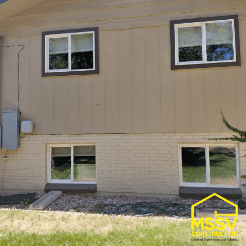 Multiple replacement windows installed on exterior of two story home.