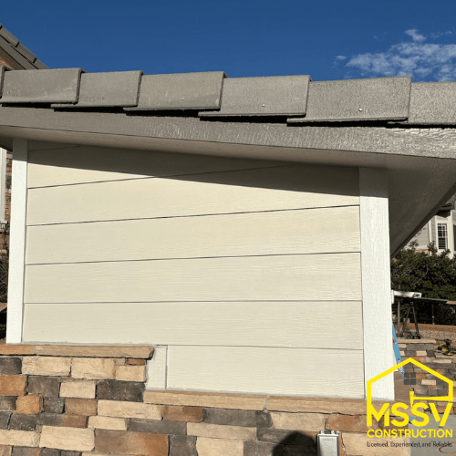New horizontal siding installation with stone accent and exterior trim