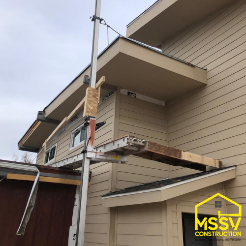 Exterior home construction with scaffolding and sing work by MSSV Construction