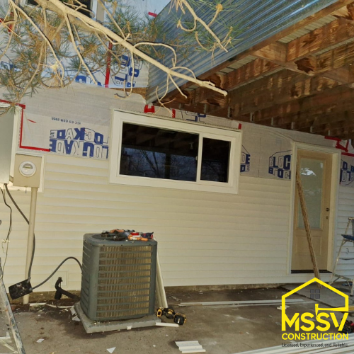 Residential exterior wall with window and outdoor AC unit by MSSV Construction
